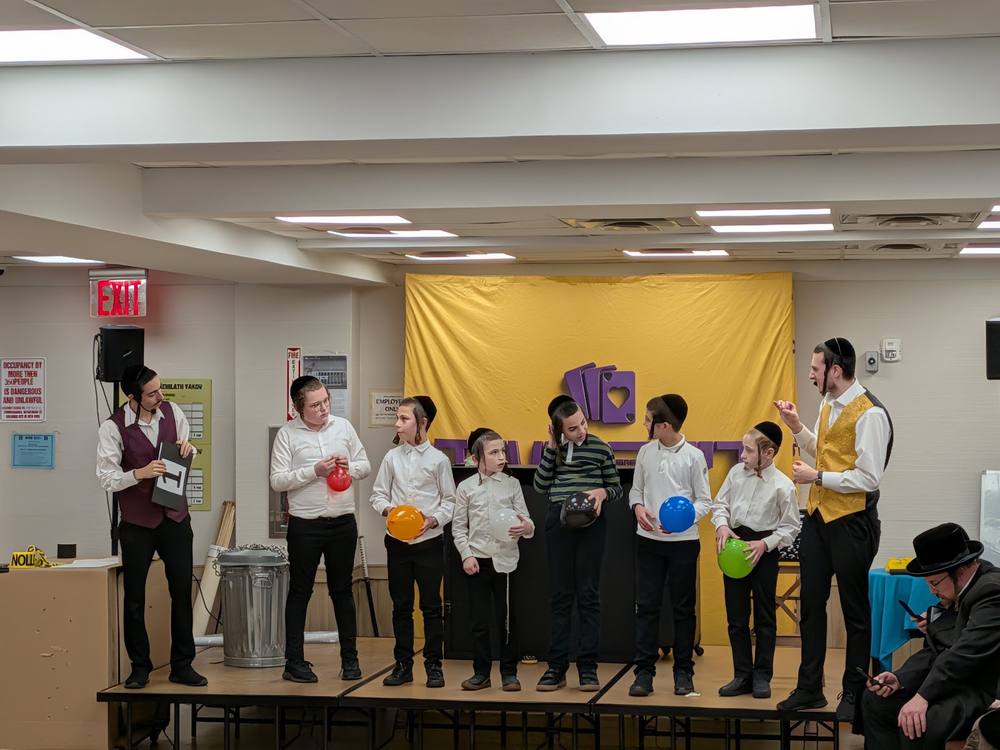 The brothers on stage with a lineup of young volunteers