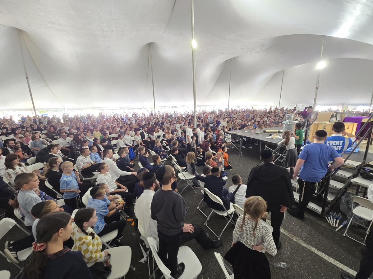 A packed tent audience